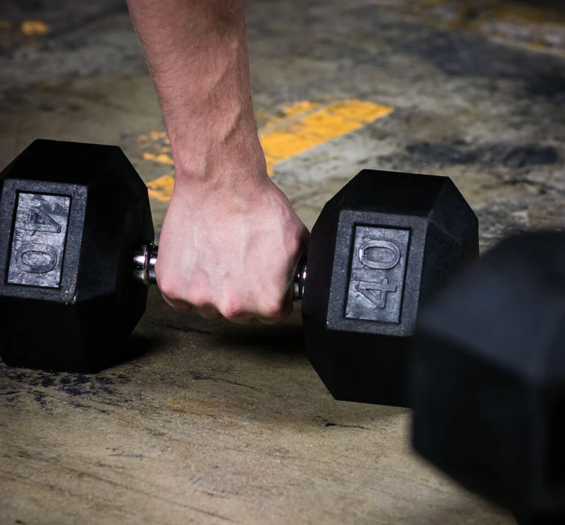 man picking up a dumbbell