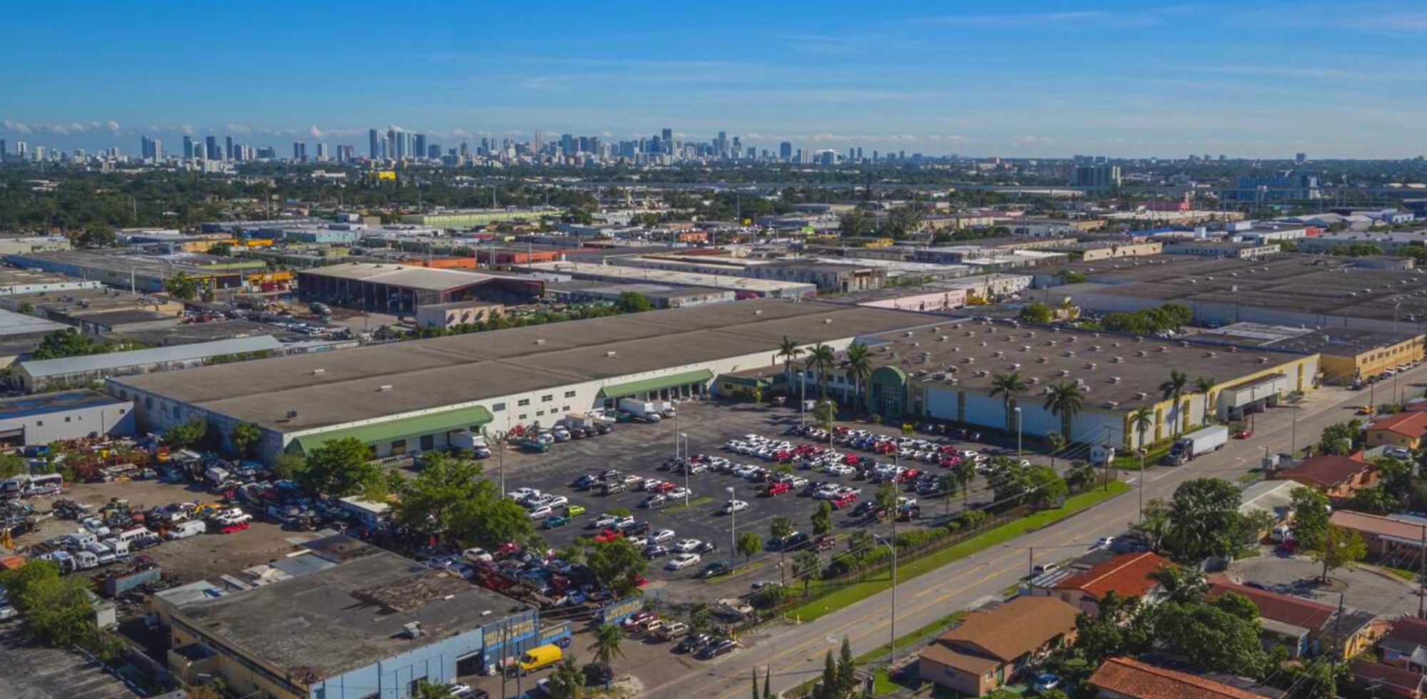 Synergy Custom Fitness's headquarters, where their weight storage equipment is manufactured, with the Miami skyline in the background.
