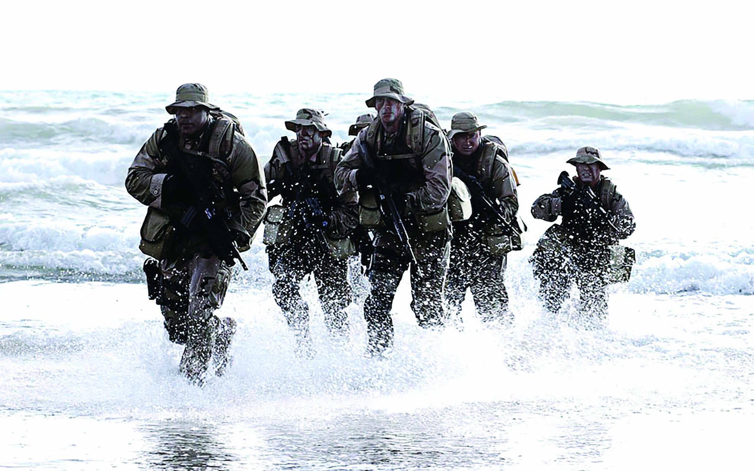 a navy seal team is coming out of the water