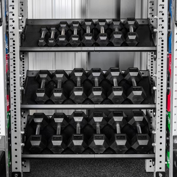 PRx straight handle hex dumbbells stored on three shelves in a home gym